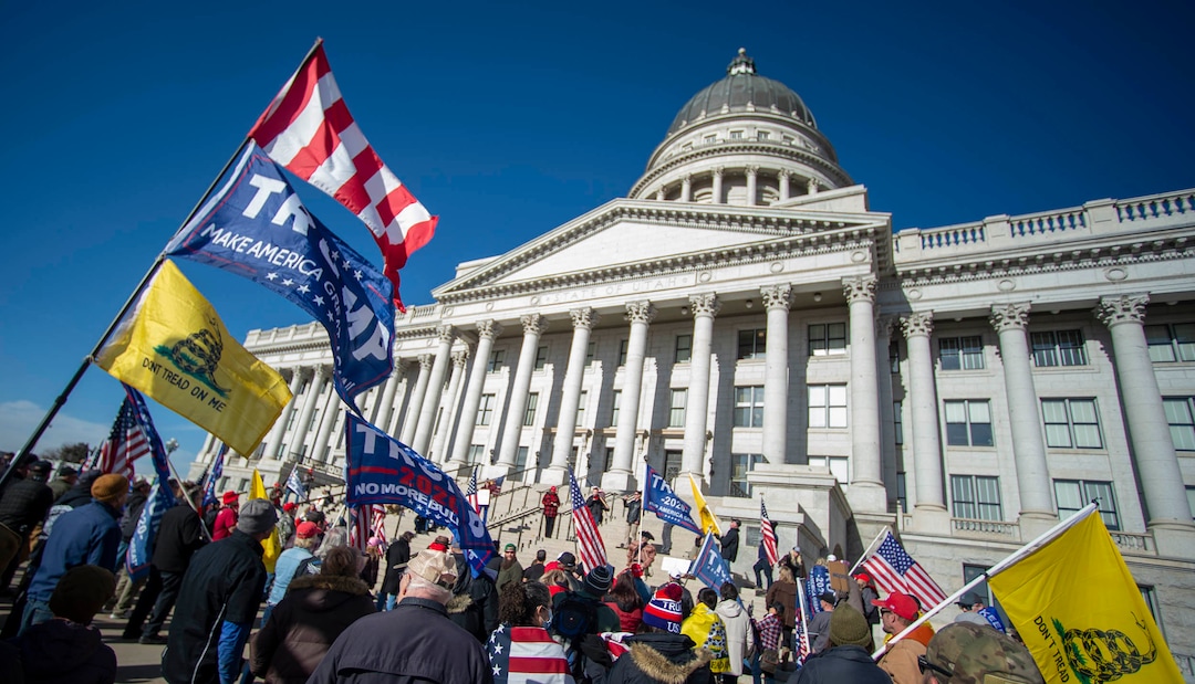 (Rick Egan | The Salt Lake Tribune). A small crowd of Trump protesters gather at the capitol with signs, flags and guns on Wednesday, Jan. 6, 2021.