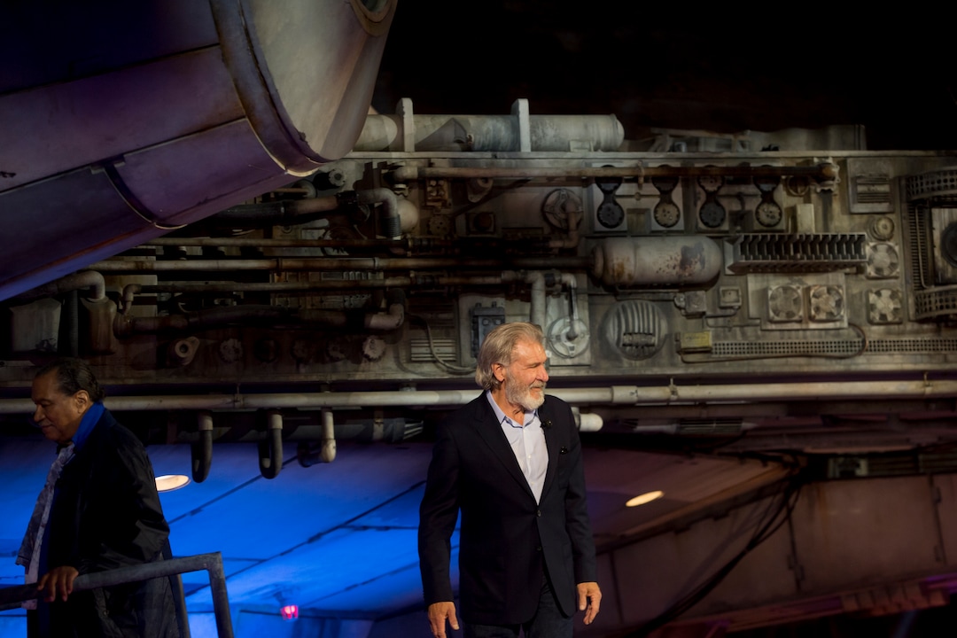 (Jeremy Harmon  |  The Salt Lake Tribune) As Billy Dee Williams leaves the stage, Harrison Ford turns take a last look at the crowd following the dedication ceremony for Star Wars: Galaxy's Edge in Anaheim, Ca. on Wednesday, May 29, 2019. Behind them is the Millennium Falcon.