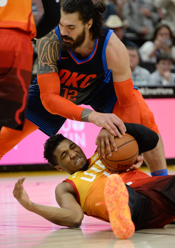 (Francisco Kjolseth  |  The Salt Lake Tribune)   Oklahoma City Thunder center Steven Adams (12) tries to steal the ball from Utah Jazz guard Donovan Mitchell (45) as he calls for a time out in the final seconds in the second half of the NBA game at Vivint Smart Home Arena Sat., Dec. 22, 2018, in Salt Lake City.