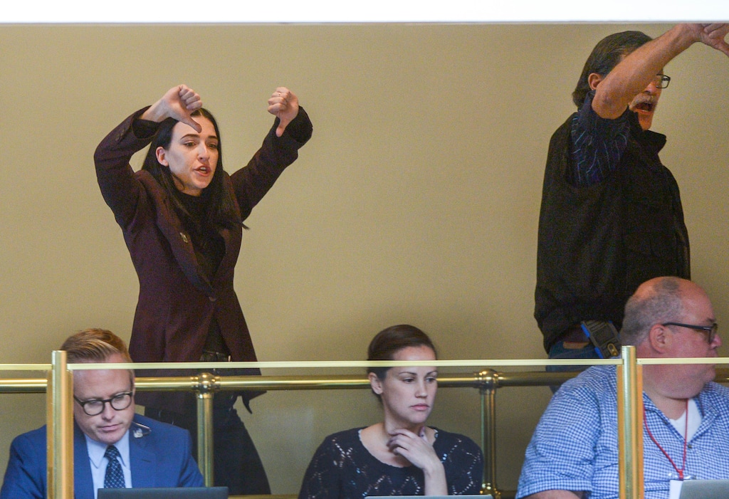 (Leah Hogsten | The Salt Lake Tribune) Aubrey Taylor Long gives two "thumbs down" to the 60 House members who voted to change the Utah Medical Cannabis Act, the bill that officials, Prop 2 opponents and medical marijuana advocates crafted and pitched as a compromise. On Monday, Dec. 2, 2018 during a special session, lawmakers voted for an overwritten version of the ballot initiative.