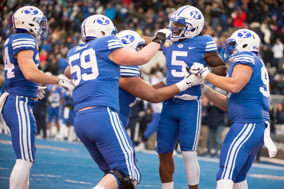 (Jeremy Harmon  |  The Salt Lake Tribune) Brigham Young Cougars defensive back Dayan Ghanwoloku (5) celebrates after scoring a touchdown as BYU faces the Western Michigan Broncos in the Famous Idaho Potato Bowl in Boise, Idaho, on Friday, Dec. 21, 2018.