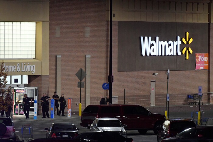 Police guard the front entrance to Walmart where a shooting occurred inside the store, Wednesday, Nov. 1, 2017, in Thornton, Colo. Thornton police tweeted Wednesday night that they were responding to a shooting with "multiple parties down." They advised people to stay away from the area as dozens of police cruisers and emergency vehicles raced to the scene. (Helen H. Richardson/The Denver Post via AP)
