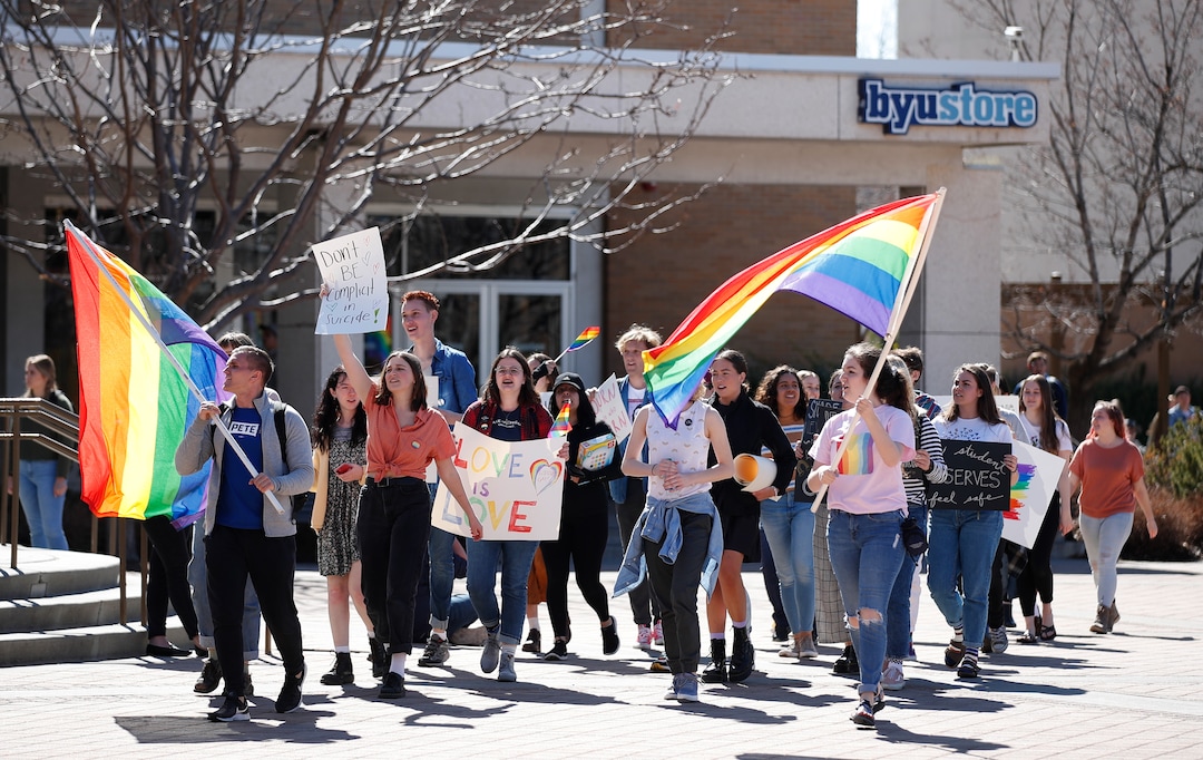 (George Frey  |  special to The Salt Lake Tribune) BYU students and others gather in front of the Ernest L. Wilkinson Student Center on the campus of Brigham Young University to protest BYUÕs rollback of a newly announced policy change on LGBTQ students on March 5, 2020 in Provo, Utah.