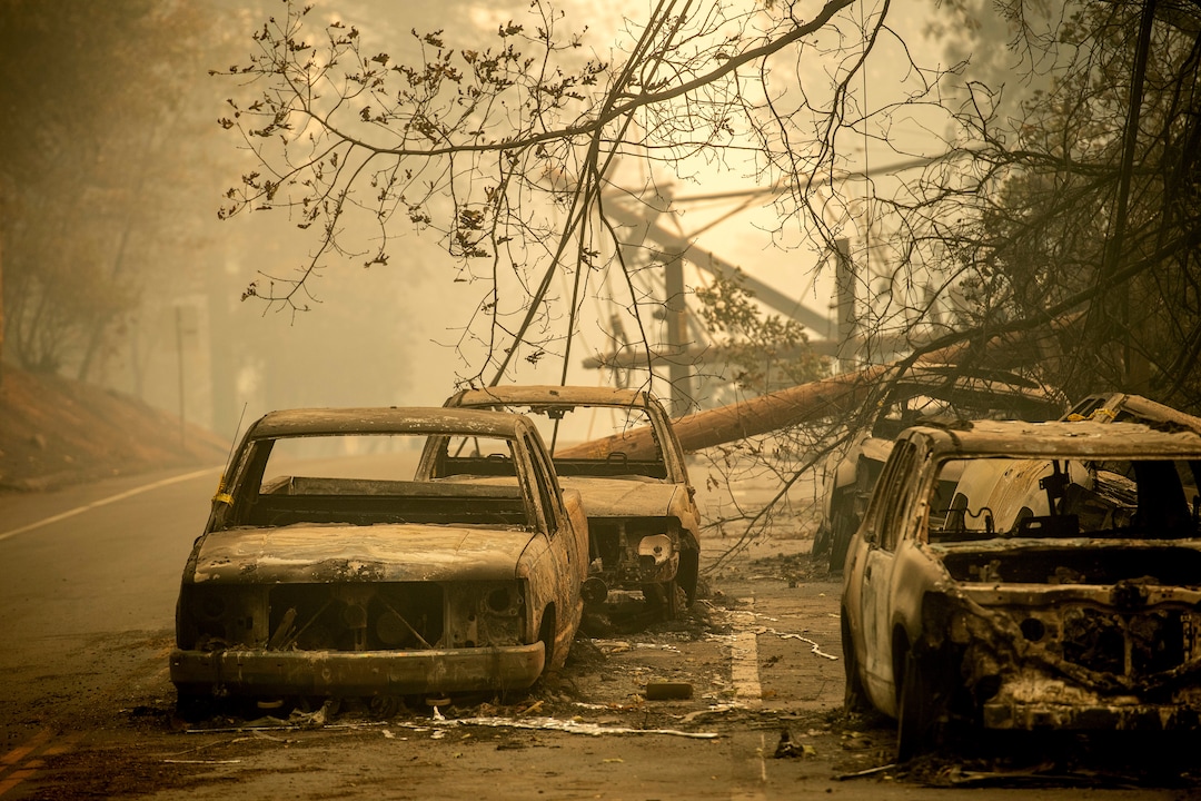 Abandoned cars, scorched by the wildfire, line Pearson Rd. in Paradise, Calif., on Saturday, Nov. 10, 2018. Not much is left in Paradise after a ferocious wildfire roared through the Northern California town as residents fled and entire neighborhoods are leveled. (AP Photo/Noah Berger)