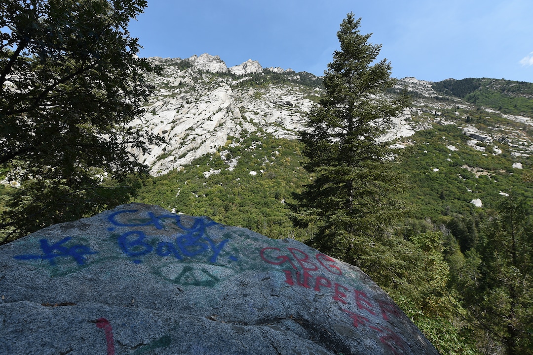 (Francisco Kjolseth  |  The Salt Lake Tribune)  Graffiti has proliferated in lower Little Cottonwood Canyon, where vandals, often wielding cans of fluorescent-colored spray paint, have covered granite faces, trees and structures. The vandalism is particularly apparent along the Temple Quarry Trail and the creek at the Moon Rock swimming hole and former pavilion site. Volunteers using donated equipment and solvents spend thousands of hours removing the paint from the rocks only to see graffiti return to the same faces or on rock nearby.