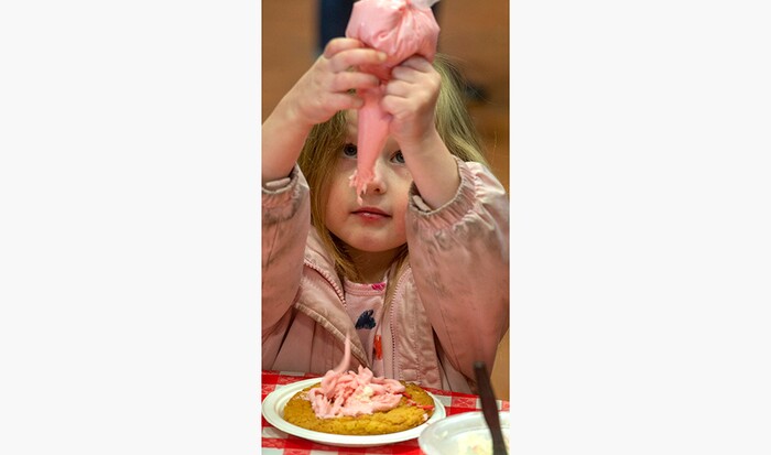 (Rick Egan | The Salt Lake Tribune) Vanessa Moore, decorates a Valentines cookie, during the 36th annual Ruby's Inn Bryce Canyon Winter Festival on Saturday, Feb. 13, 2021.