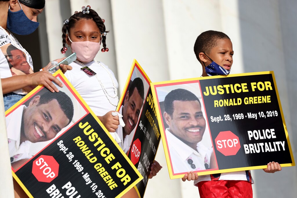 Family members of Ronald Greene listen to speakers as demonstrators gather for the March on Washington, Friday Aug. 28, 2020, in Washington, on the 57th anniversary of the Rev. Martin Luther King Jr.’s “I Have A Dream” speech. (Michael M. Santiago/Pool via AP)