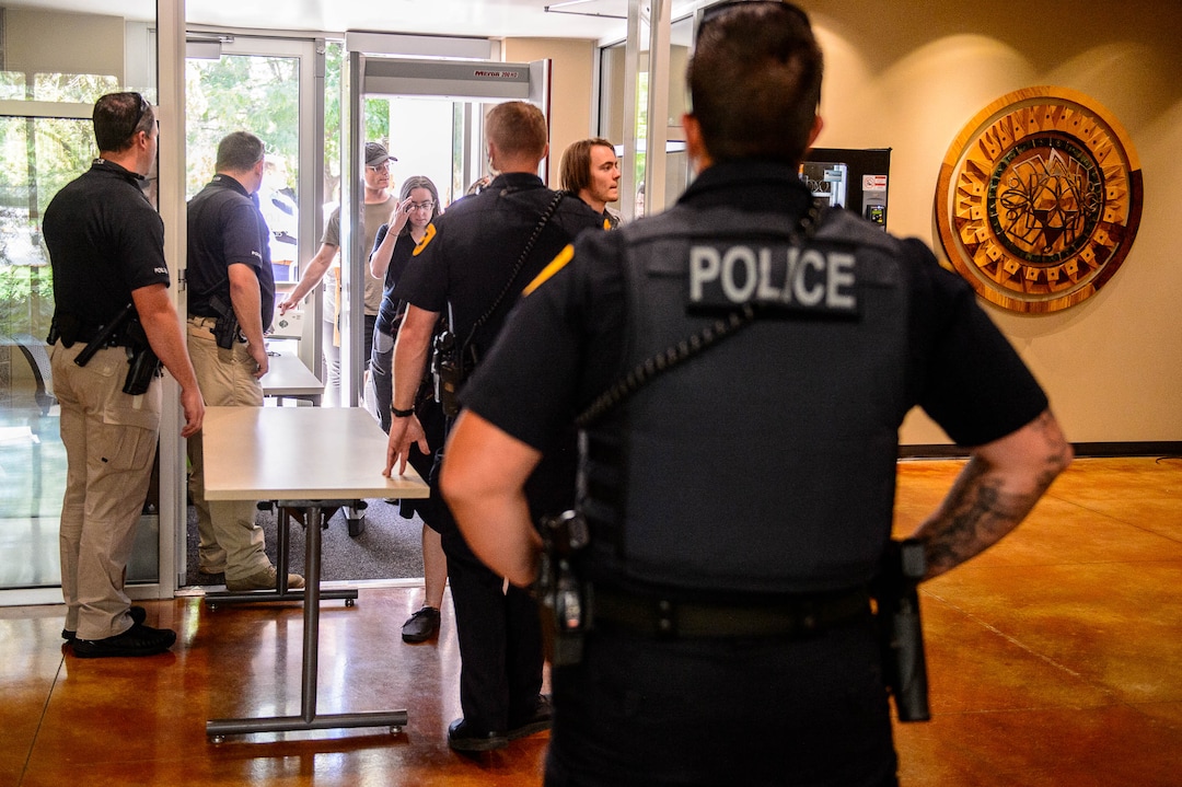 (Trent Nelson  |  The Salt Lake Tribune)  
Law enforcement run a security screening before a meeting of an inland port satellite working group held at a police precinct in Salt Lake City on Wednesday, Aug. 14, 2019.