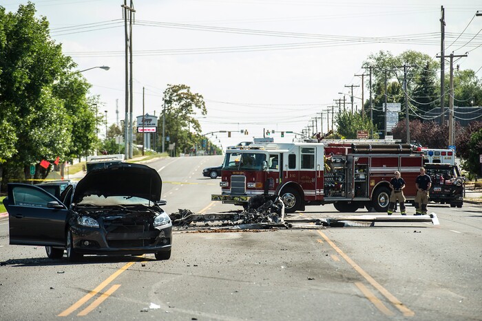(Chris Detrick  |  The Salt Lake Tribune)  The scene of a plane crash at 1900 West and 4500 South  in Roy Tuesday, September 12, 2017. The pilot of a single-engine airplane survived a fiery crash on a street in Roy Tuesday afternoon, authorities said. Roy police Sgt. Matthew Gwynn said the pilot was transported to a hospital “out of precaution,” as was the driver of a car that the plane hit.