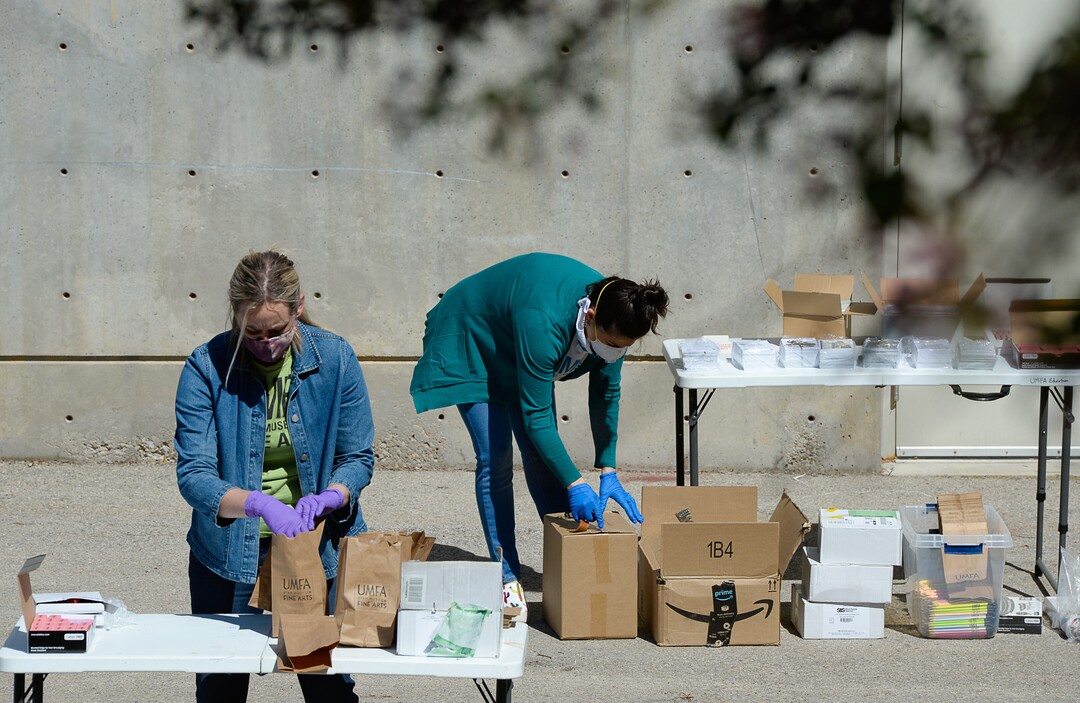 (Francisco Kjolseth  |  The Salt Lake Tribune) UMFA learning engagement team members Ashley Farmer, left, and Annie Burbidge Ream assemble "UMFA Art Kits," to provide art supplies to high school students to help them complete end-of-year course work. The volunteers filled 1,500 kits with colored pencils, postcards and art activities on Friday, May 4, 2020, to help kids in the Granite School District and Whitehorse High School in San Juan County, to finish school projects and get excited about home projects during the coronavirus pandemic.