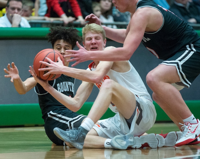 (Rick Egan  |  The Salt Lake Tribune)   Bountiful Braves Isaac Kime (0) and Bountiful Braves Brig Willard (10) go for the ball, as Skyridge Falcons Duncan Reid (3) tries to keep control of the ball in 5A basketball playoff action between the Bountiful Braves and Skyridge Falcons, at the UCCU Center in Orem, Monday, Feb. 26, 2018.
