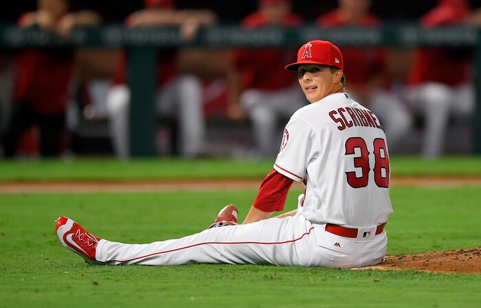 Los Angeles Angels starting pitcher Troy Scribner sits on the ground after falling off the mound while pitching during the fifth inning of the team's baseball game against the Oakland Athletics, Friday, Aug. 4, 2017, in Anaheim, Calif. (AP Photo/Mark J. Terrill)