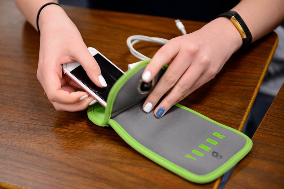 (Trent Nelson | The Salt Lake Tribune) Students in Monta Thomas' classes at Brighton High School in Cottonwood Heights secure their phones in locking pouches made by Yondr.