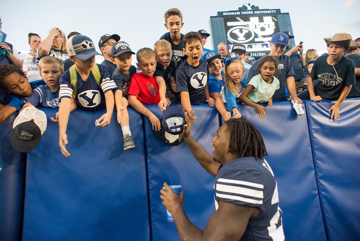 (Rick Egan  |  The Salt Lake Tribune)    Brigham Young Cougars running back Squally Canada (22) high-fives the crowd after the Brigham Young Cougars defeated the McNeese State Cowboys 30-3, at Lavell Edwards Stadium, Saturday, Sept. 22, 2018.


