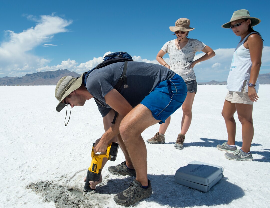 (Rick Egan  |  The Salt Lake Tribune) University of Utah graduate student Jeremiah Bernau cuts a sample of salt crust along with Emily Kam, Hannah Stimson, while doing research with University of Utah professor Brenda Bowen on the effects human of activity  on the salt crust. Thursday, August 10, 2017. 