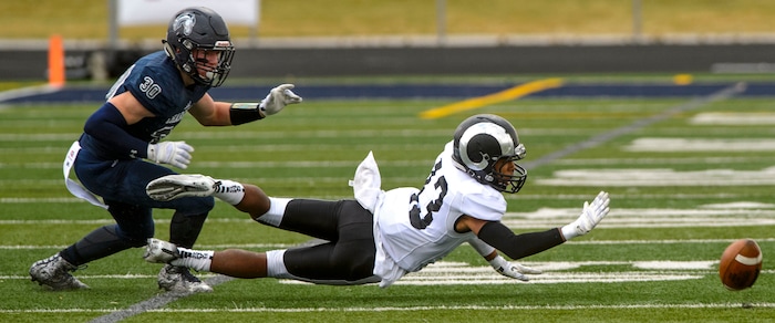 (Steve Griffin  |  The Salt Lake Tribune)  Highland wide receiver Ousmane Doumbia can't make the catch in front of Corner Canyon defender Caden Johnson during the Class 5A state quarterfinal football game at Corner Canyon in Draper Friday November 3, 2017.