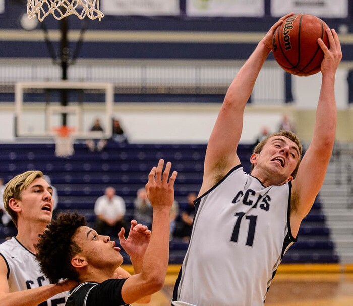 (Trent Nelson | The Salt Lake Tribune)  Corner Canyon's Ammon Jensen (11) pulls down a rebound as Corner Canyon faces Bountiful in the title game of the Corner Canyon Tournament of Champions, high school boys' basketball in Draper, Saturday December 2, 2017.