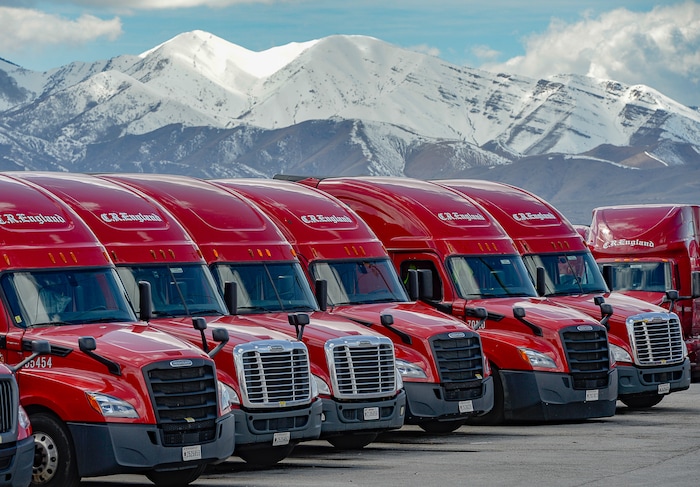 (Francisco Kjolseth | The Salt Lake Tribune) Trucks come and go at C.R. England trucking in Salt Lake City on Monday, March 30, 2020. The coronavirus outbreak has helped make truckers heroes as they help to stock empty shelves in stores. Drivers face new challenges from finding restrooms and food on the road amid shutdowns, but say they enjoy driving with no congestion.