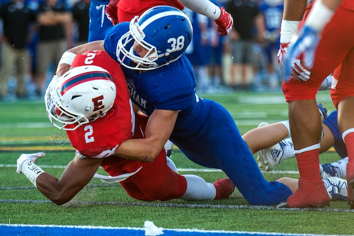 (Chris Detrick  |  The Salt Lake Tribune)  Bingham's Cole Moody (38) stops East's Sione Molisi (2) during the game at Bingham High School Friday, August 25, 2017. Bingham is winning the game 24-17 at halftime. 