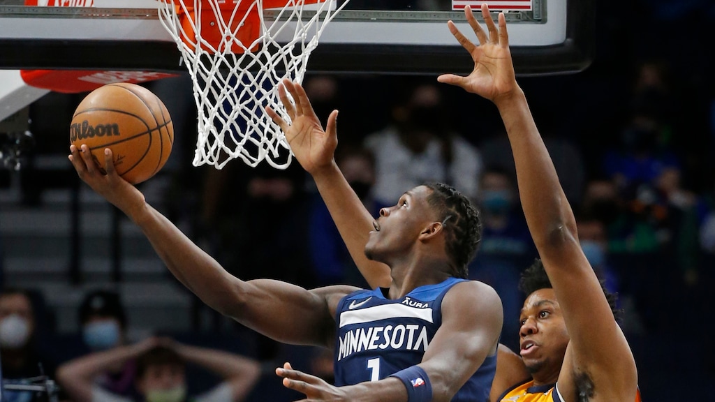Minnesota Timberwolves forward Anthony Edwards (1) goes to the basket as Utah Jazz center Hassan Whiteside (21) defends against him in the second quarter of an NBA basketball game Sunday, Jan. 30, 2022, in Minneapolis. (AP Photo/Bruce Kluckhohn)