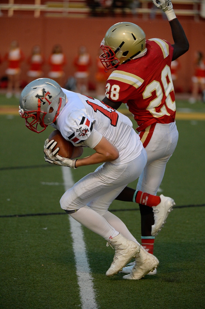 (Francisco Kjolseth  |  The Salt Lake Tribune)  Travis Thompson of Manti pulls in a long pass while pressured by  Fredrick Charles of Judge in the Class 3A football playoff game at Judge Memorial on Thursday, Oct. 19, 2017. 