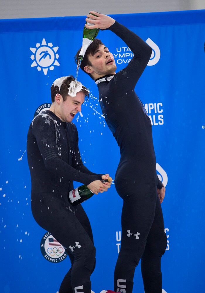 (Scott Sommerdorf   |  The Salt Lake Tribune)   
John-Henry Krueger backhands the champagne celebration onto Ryan Pivirotto at the of the U.S. short-track Olympic Team Trials at the Utah Olympic Oval, Sunday, December 17, 2017.  
