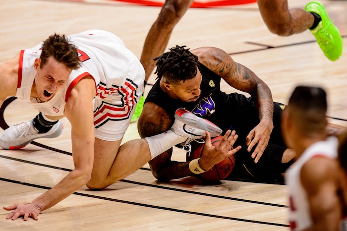 (Trent Nelson | The Salt Lake Tribune) Washington's Nate Roberts steals the ball from Utah's Mikael Jantunen as Utah hosts Washington, NCAA basketball in Salt Lake City on Thursday, Dec. 3, 2020.