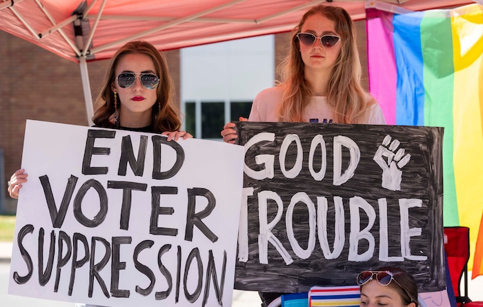 (Rick Egan | The Salt Lake Tribune) Karaline Taylor and Paige Yorgeson encourage participants to register to vote, as the Layton Liberty Days parade, on Monday, July 5, 2021.