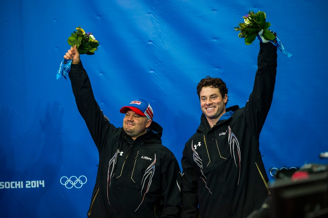 KRASNAYA POLYANA, RUSSIA  - JANUARY 17:Pilot Steven Holcomb, left, and brakeman Steven Langton, celebrate after competing in the men's two-man bobsled at Sanki Sliding Center during the 2014 Sochi Olympics Monday February 17, 2014. USA-1 with Steven Holcomb, of Park City, Utah, and Steve Langton, of Melrose, Mass., won the bronze medal with a time of 3:46.27.(Photo by Chris Detrick/The Salt Lake Tribune)
