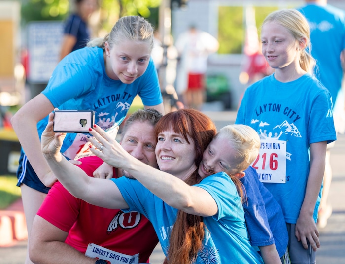 (Rick Egan | The Salt Lake Tribune) A family snaps a selfie before the 5K Fun Run, at the Layton Liberty Days, on Monday, July 5, 2021.