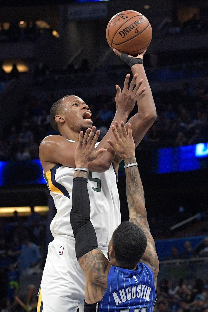 Utah Jazz guard Rodney Hood (5) goes up for a shot in front of Orlando Magic guard D.J. Augustin (14) during the first half of an NBA basketball game, Saturday, Nov. 18, 2017, in Orlando, Fla. (AP Photo/Phelan M. Ebenhack)