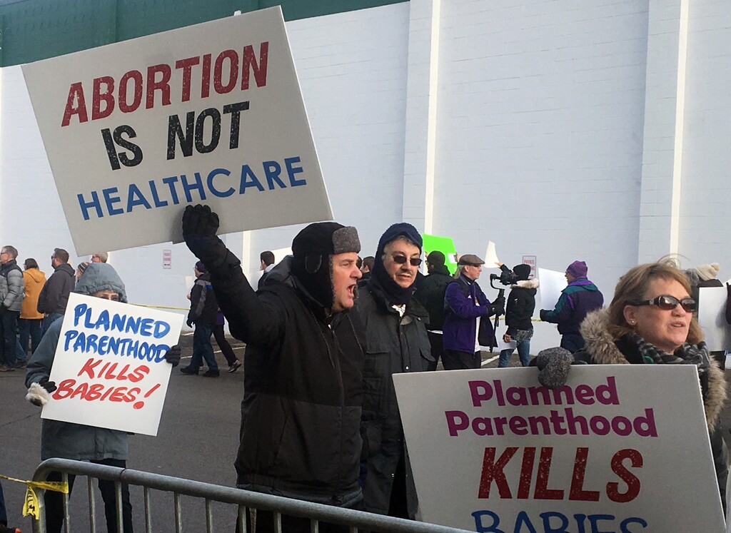 Abortion opponents rally outside Planned Parenthood in St. Paul, Minn., on Saturday, Feb. 11, 2017. Rallies aimed at urging Congress and President Donald Trump to end federal funding for Planned Parenthood are scheduled across the country. (AP Photo/Jeff Baenen)