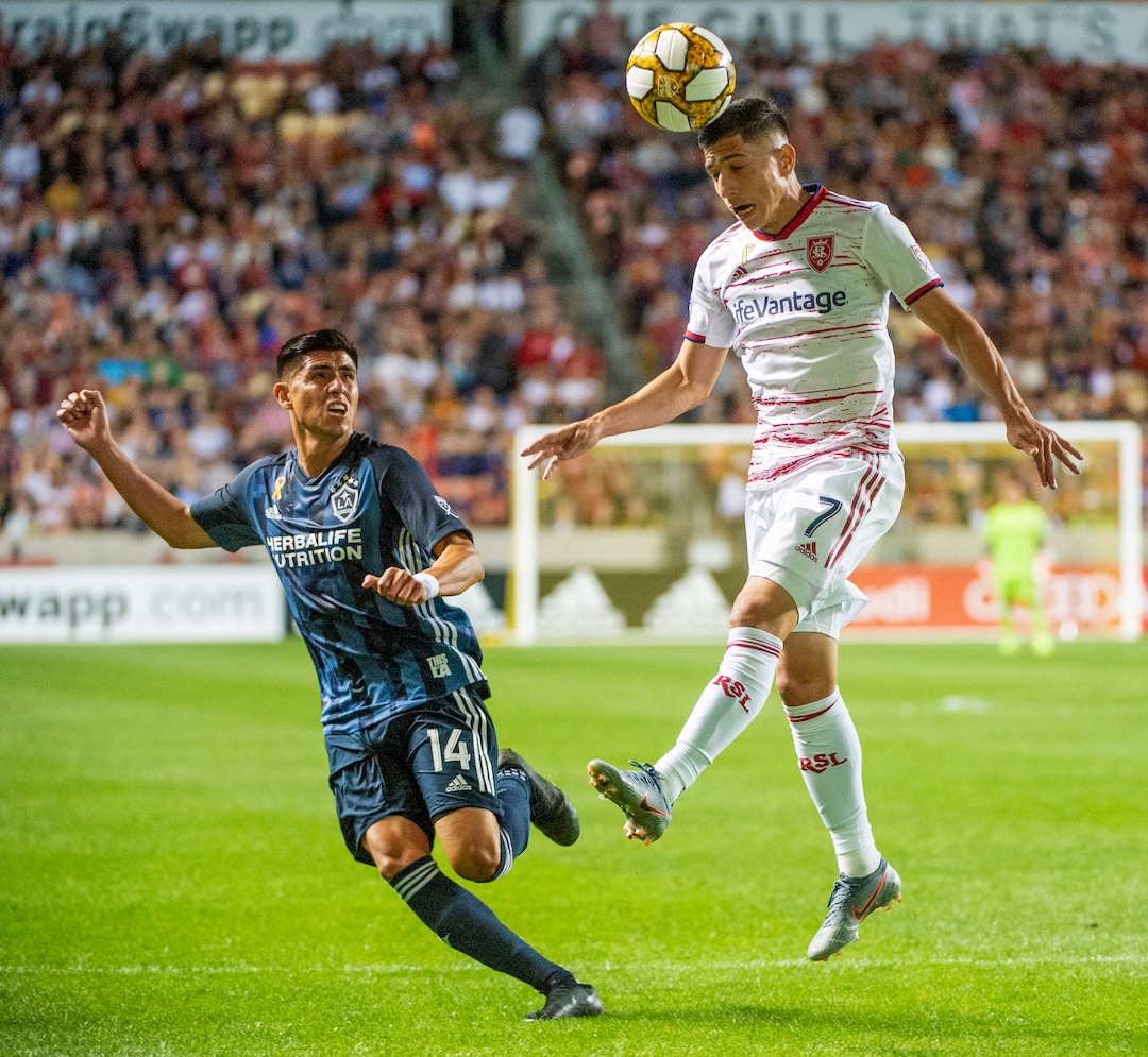 (Rick Egan  |  The Salt Lake Tribune)   Real Salt Lake forward Jefferson Savarino (7) heads the ball as Los Angeles Galaxy midfielder Joe Corona (14) defends, in MLS soccer action between Real Salt Lake and Los Angeles Galaxy at Rio Tinto Stadium, Wednesday, Sept. 25, 2019.