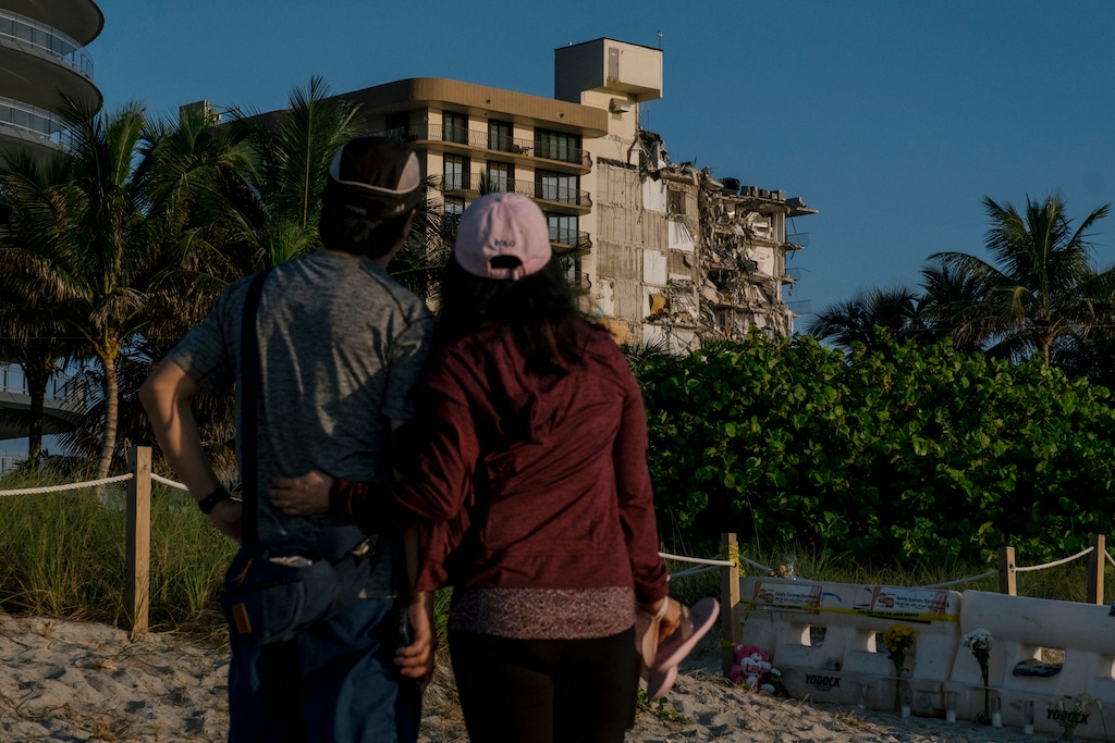 (Mark Abramson/The New York Times)

A couple visits the site of the collapsed Champlain Towers South condominium in Surfside, Fla., July 4, 2021.