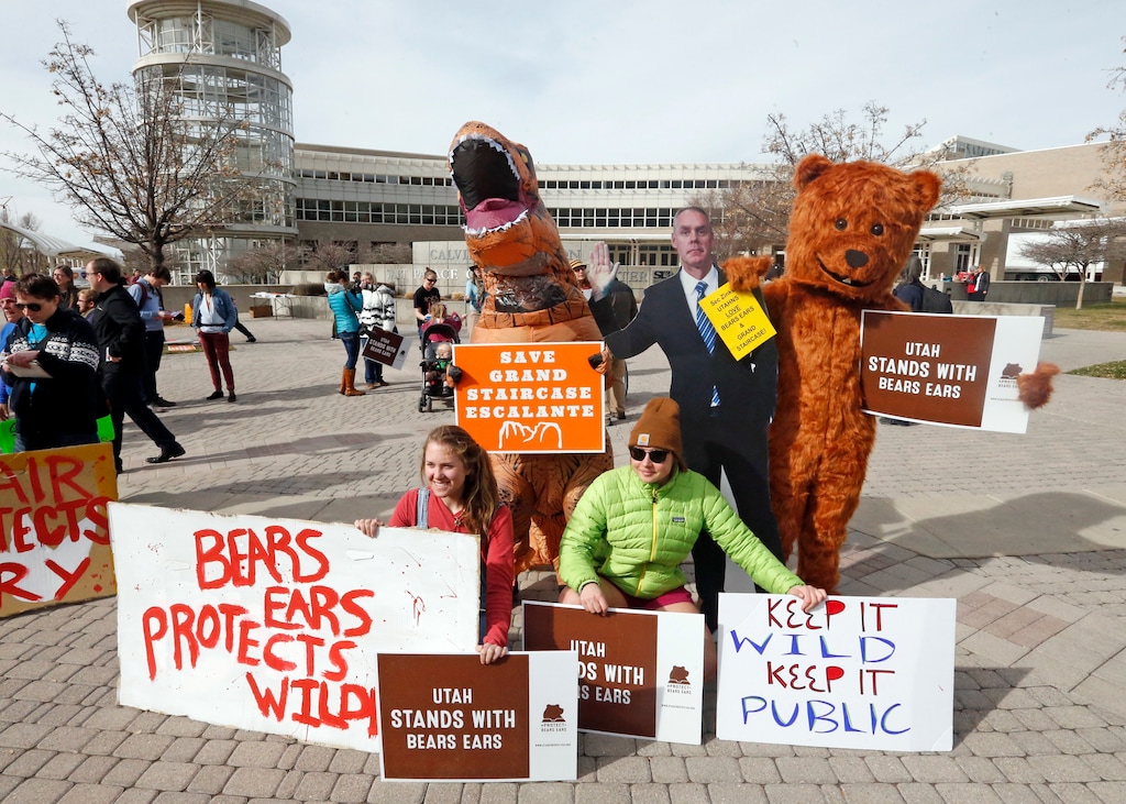 (Rick Bowmer | AP file photo) People gather to stand in support of Bears Ears and Grand Staircase-Escalante National Monuments on the day Interior Secretary Ryan Zinke is speaking during a conservation and hunting expo Friday, Feb. 9, 2018, in Salt Lake City. Protests are planned by environmental groups who are upset that Zinke recommended shrinking two sprawling national monuments in Utah.