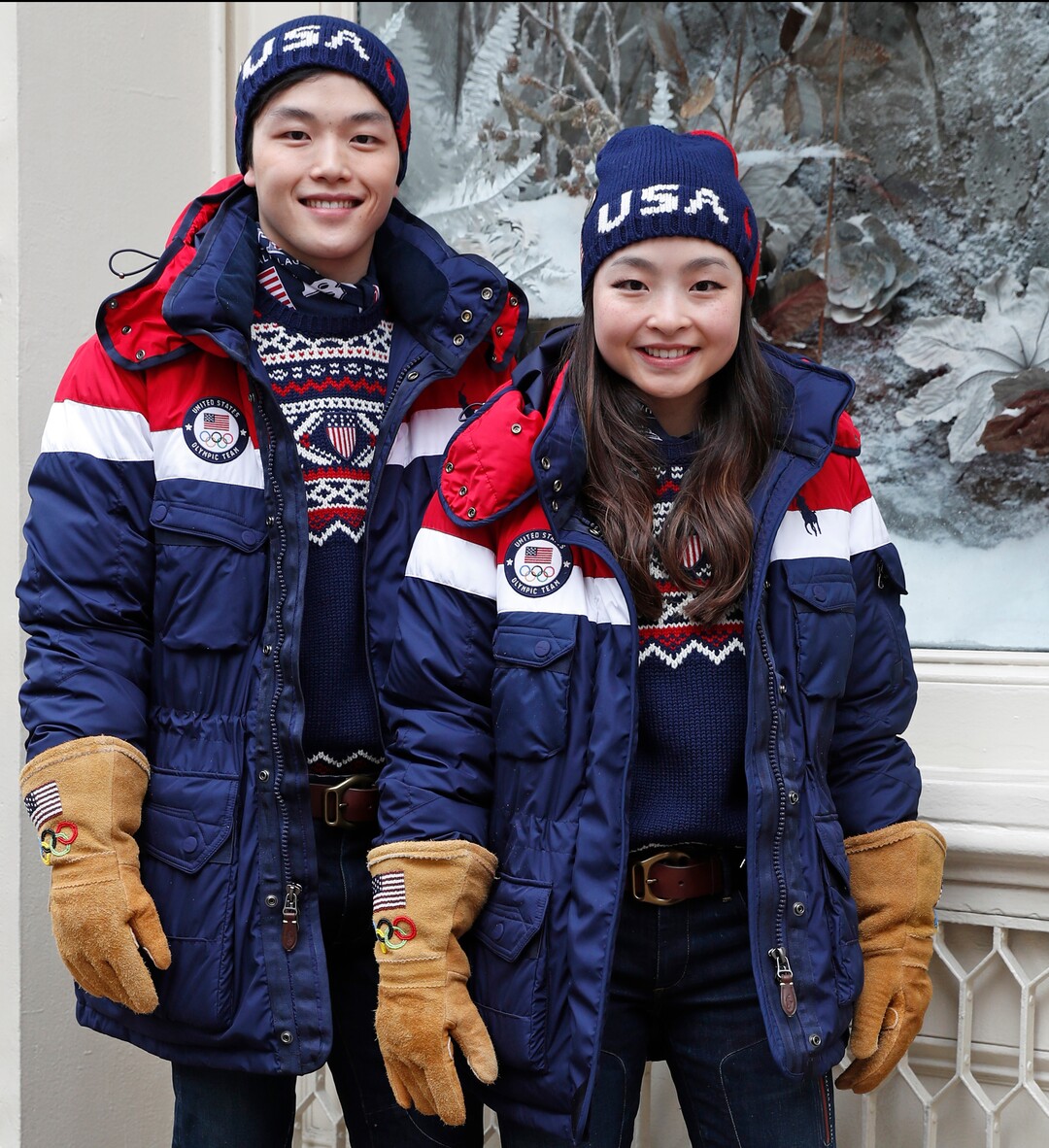 Ice dancing pair Alex and Maia Shibutani, a brother and sister team, pose for photographs wearing Team USA Opening Ceremony uniforms designed by David Lauren for Polo Ralph Lauren, Monday, Jan. 22, 2018, outside the brand's Prince Street store in New York. The parkas have a battery-operated, built-in heating element that can be adjusted using a cell phone. (AP Photo/Kathy Willens)