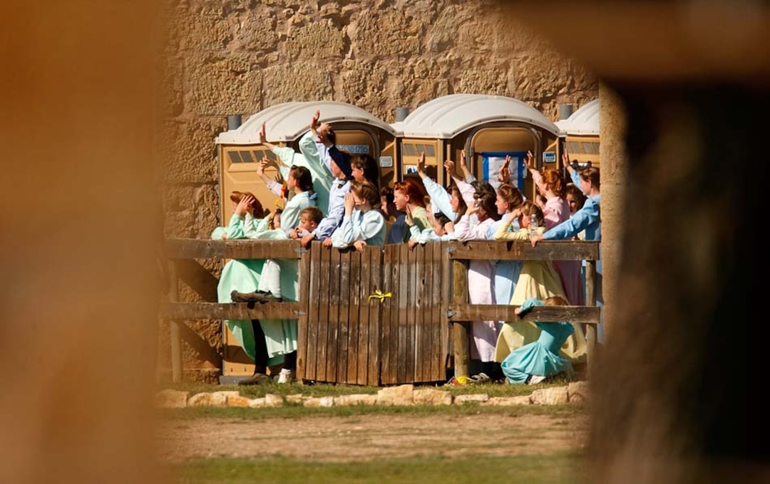 (Trent Nelson | The Salt Lake Tribune)San Angelo, Texas - Young FLDS women gather behind a fence at Fort Concho, waving to other FLDS women in another building out of view. Texas Child Protective Services and Texas State Troopers made every effort to keep the nearly 500 women and children in custody out of view, going so far as to confiscate cel phones and other electronic devices.