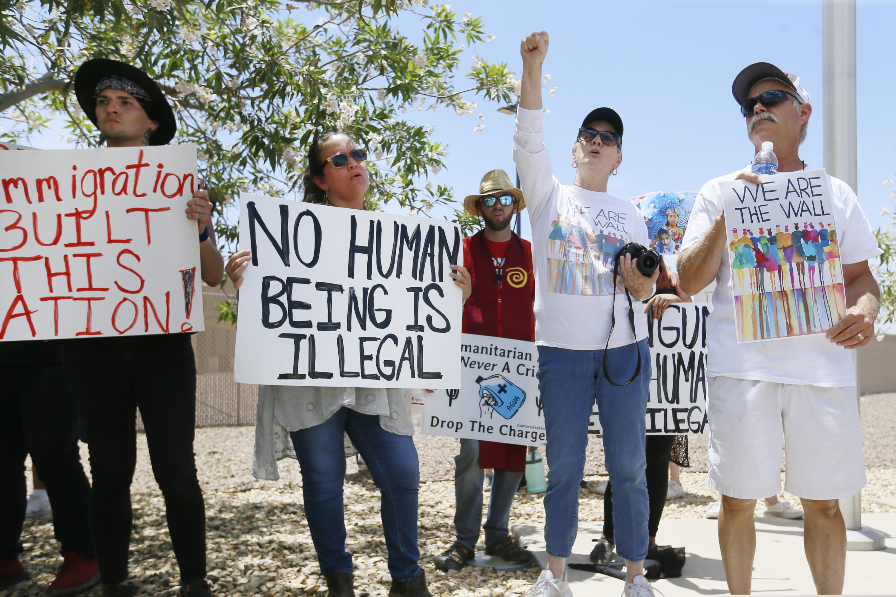 (Briana Sanchez | El Paso Times | AP) Protesters gather at the front of the Clint Border Patrol station to hear U.S. and Texas lawmakers talk about what they thought of the area facilities they toured Monday, July 1, at the Border Patrol station in Clint.