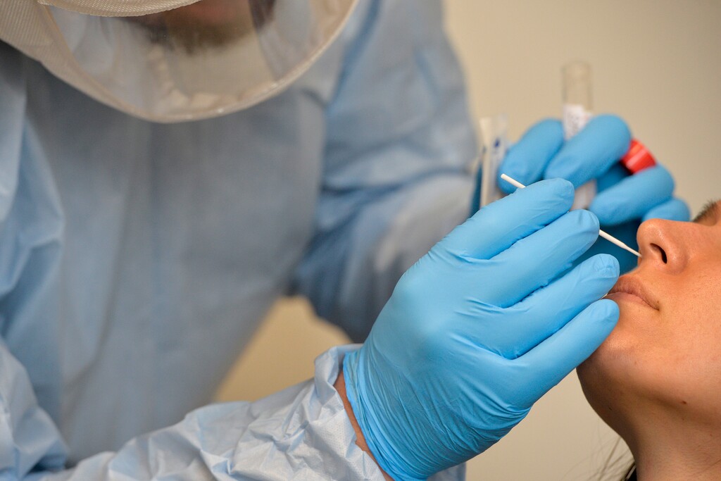(Chris Samuels | The Salt Lake Tribune) Zack Kolesky administers a coronavirus test to a woman at a center run by Granite School District and the Salt Lake County Department of Health near Thomas Jefferson Junior High in Kearns, Tuesday, Jan. 4, 2022.