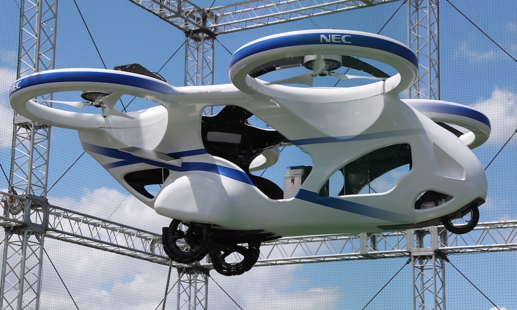 NEC Corp.'s machine with propellers hovers at the company's facility in Abiko near Tokyo, Monday, Aug. 5, 2019. The Japanese electronics maker showed a "flying car," a large drone-like machine with four propellers that hovered steadily for about a minute. (AP Photo/Koji Sasahara)