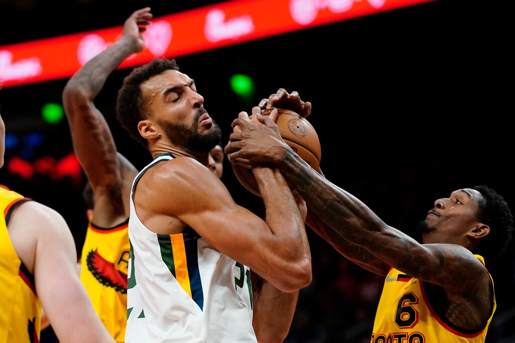Utah Jazz center Rudy Gobert (27) and Atlanta Hawks guard Lou Williams (6) vie for the ball during the first half of an NBA basketball game Thursday, Nov. 4, 2021, in Atlanta. (AP Photo/John Bazemore)