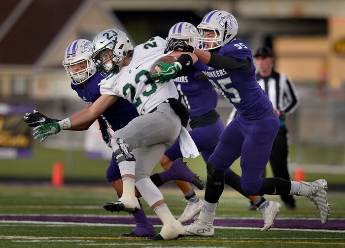 (Scott Sommerdorf   |  The Salt Lake Tribune)   Lehi's defense stops Olympus RB Robbie Ballam during first half play. Lehi led Olympus 26-0 late in the second half, Friday, September 22, 2017.