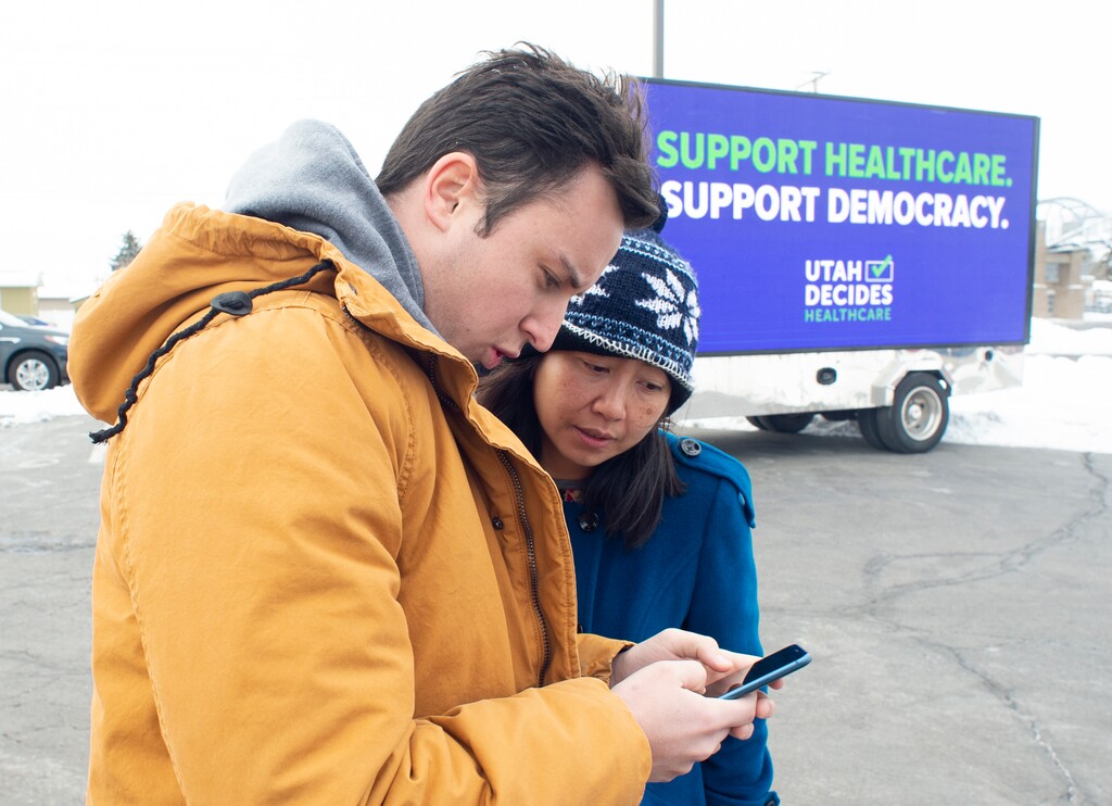 (Rick Egan  |  The Salt Lake Tribune)  Keaton Hill talks to Dawn Le as they plan to canvas a neighborhood in Taylorsville with other supporters of the fuller Medicaid expansion, urging residents to call their senator, Saturday, Feb. 9, 2019. 