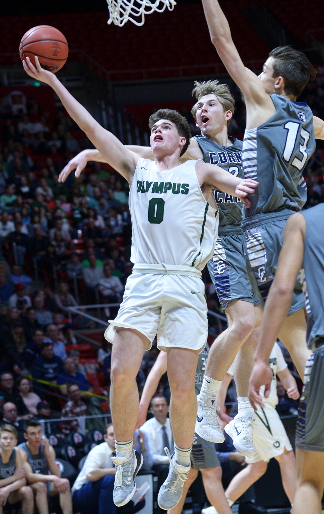 (Leah Hogsten  |  The Salt Lake Tribune) Olympus' Jeremy DowDell (00) battles Corner Canyon's John Mitchell (02) and Corner Canyon's Hayden Welling (13) at the net. Olympus plays Corner Canyon for the 5A High School BoysÕ Basketball Tournament Championship at the Jon M. Huntsman Center in Salt Lake City,  Saturday, March 3, 2018.