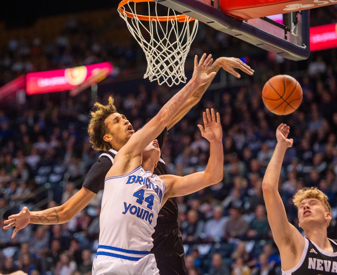 (Rick Egan  |  The Salt Lake Tribune)        Nevada Wolf Pack forward K.J. Hymes (42) blacks a shot by Brigham Young Cougars guard Connor Harding (44), in basketball action between the Brigham Young Cougars and the Nevada Wolf Pack, at the Marriott Center, in Provo, Saturday, December 10, 2019.