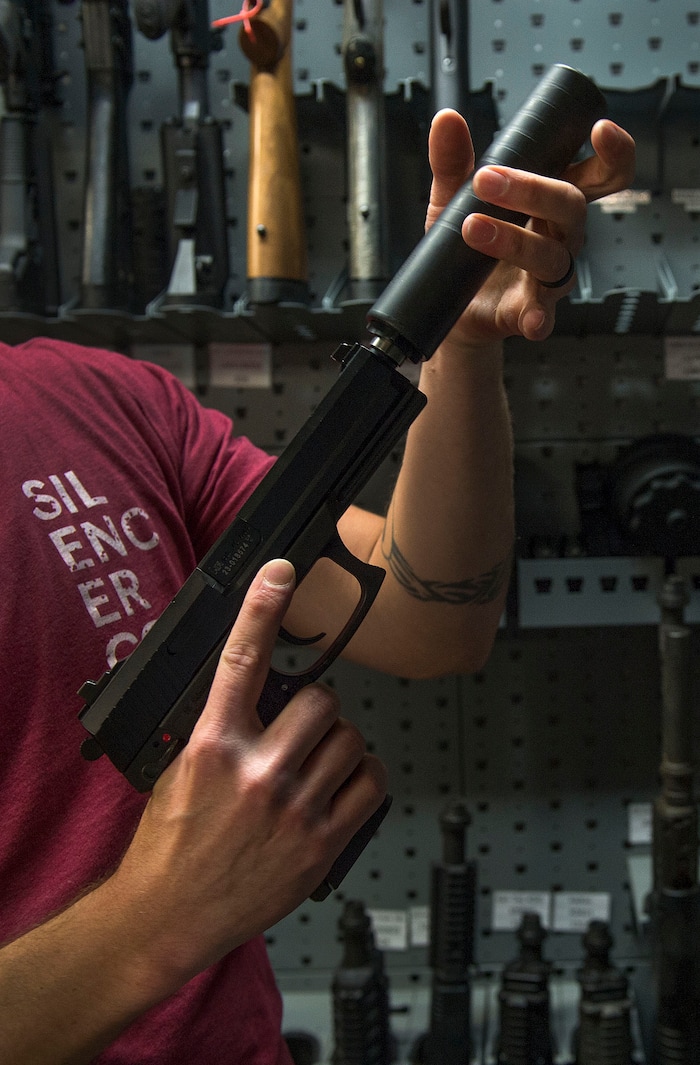 Leah Hogsten | The Salt Lake Tribune
Silencerco's public relations specialist Matt Pinnell places Silencerco's Omega K silencer on a .45 caliber pistol in the company's gun safe. Silencerco is one of the country's largest manufacturers of silencer for guns of all kinds, Friday, May 28, 2017.