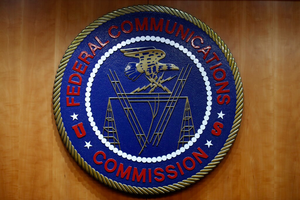 FILE - In this Dec. 14, 2017, file photo, the seal of the Federal Communications Commission (FCC) is seen before an FCC meeting to vote on net neutrality in Washington. The Senate has narrowly approved President Donald Trump’s lame-duck nominee, Nathan Simington, on Tuesday, Dec. 8, 2020, to become a member of the Federal Communications Commission. (AP Photo/Jacquelyn Martin, File)