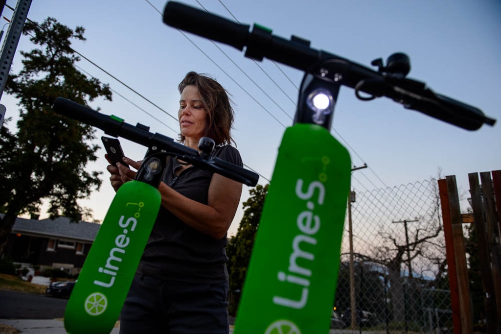 (Trent Nelson | The Salt Lake Tribune)
Jenn Hein activates scooters in Salt Lake City early Wednesday Aug. 8, 2018. Hein works as a "Bird charger" on the side to make some extra cash, picking up and charging electric scooters overnight and returning them to the city streets in the early morning.