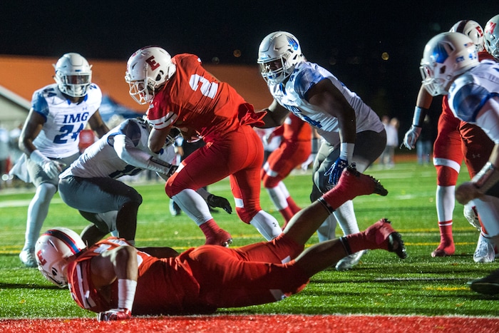 (Chris Detrick  |  The Salt Lake Tribune)  East's Sione Molisi (2) scores a touchdown past IMG Academy's Charles Thomas (11) during the game at East High School Friday, October 20, 2017. 