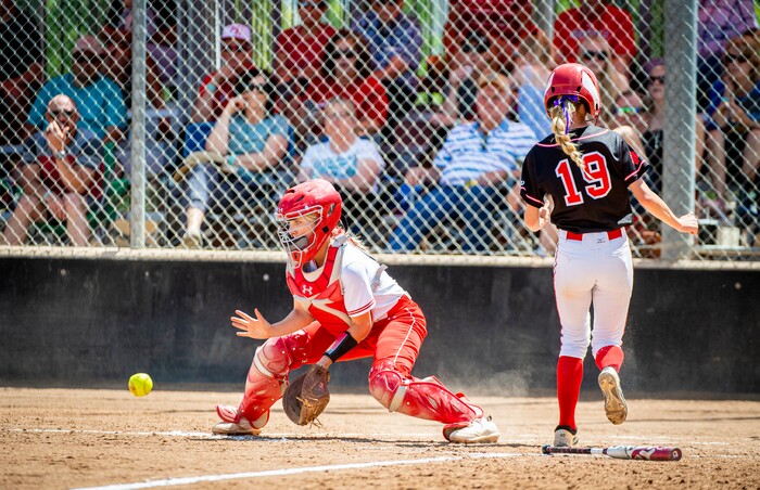 (Isaac Hale | Special to The Tribune) Spanish Fork pitcher Aubree Leonard (19) steps onto home plate for a run before Mountain Ridge catcher Tasha Hokanson (15) can catch the ball during the second game of a best-of-three series between the Spanish Fork Lady Dons and the Mountain Ridge Sentinels as part of the 5A state softball championship held at the Spanish Fork Sports Park on Friday, May 28, 2021.